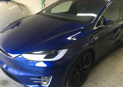 Front view of a Tesla Model X finished in blue stealth PPF wrap