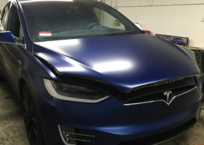 Tesla Model X with XPEL paint protection film applied in a San Diego bay