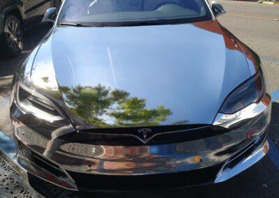 Tesla wrapped in a metallic chrome finish parked outdoors in San Diego