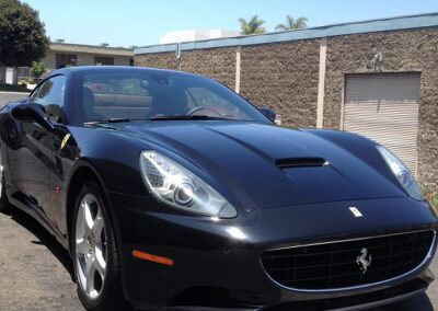 Black Ferrari California with clear bra paint protection film outside the San Diego shop