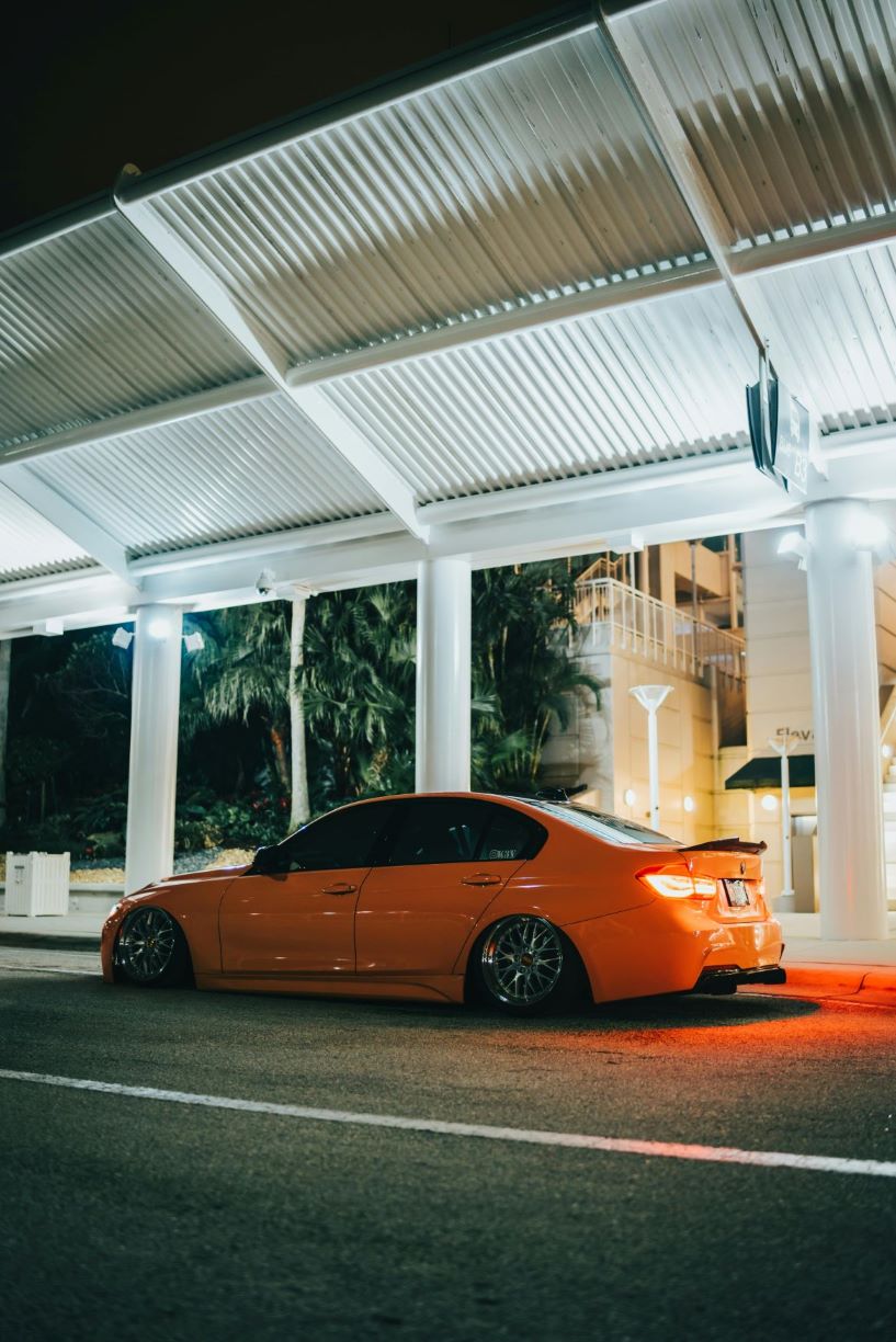 orange bmw with tinted windows